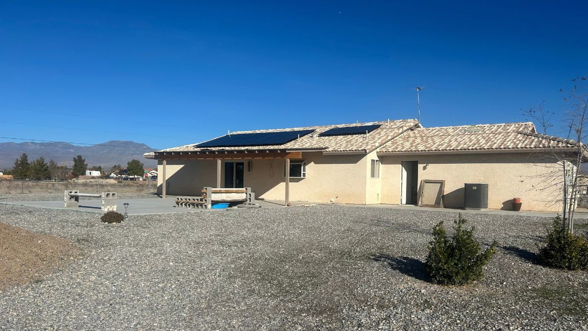 Exterior view of 3550 S Newberry Ave in Pahrump showing rooftop solar array and desert landscape