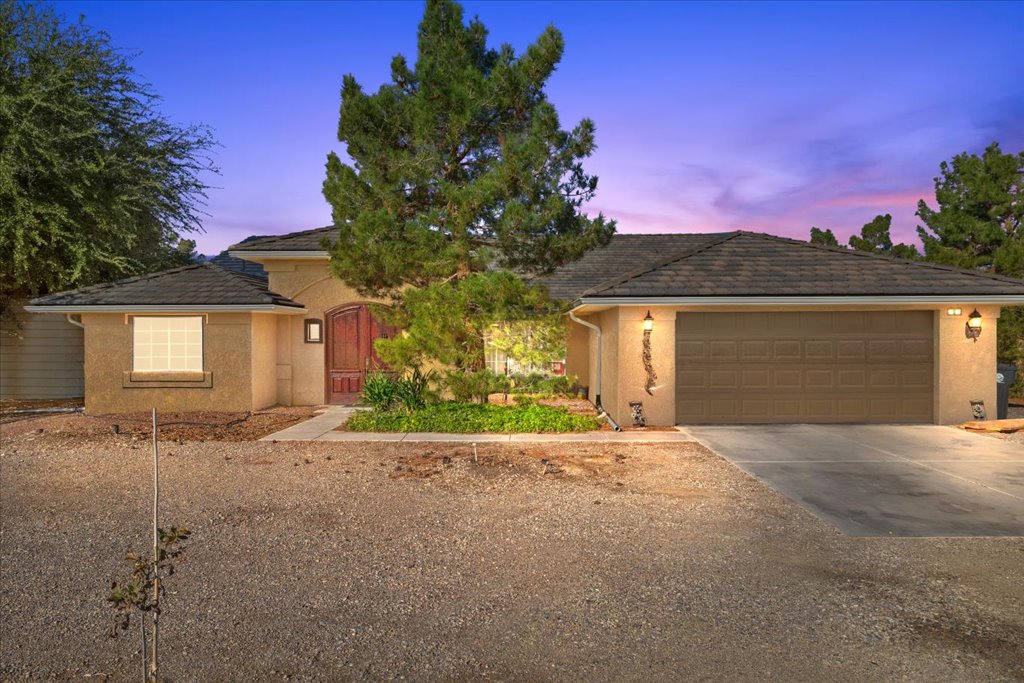 Front exterior and circular driveway of the gated solar compound at 3780 S Ranger Way in Pahrump, Nevada.